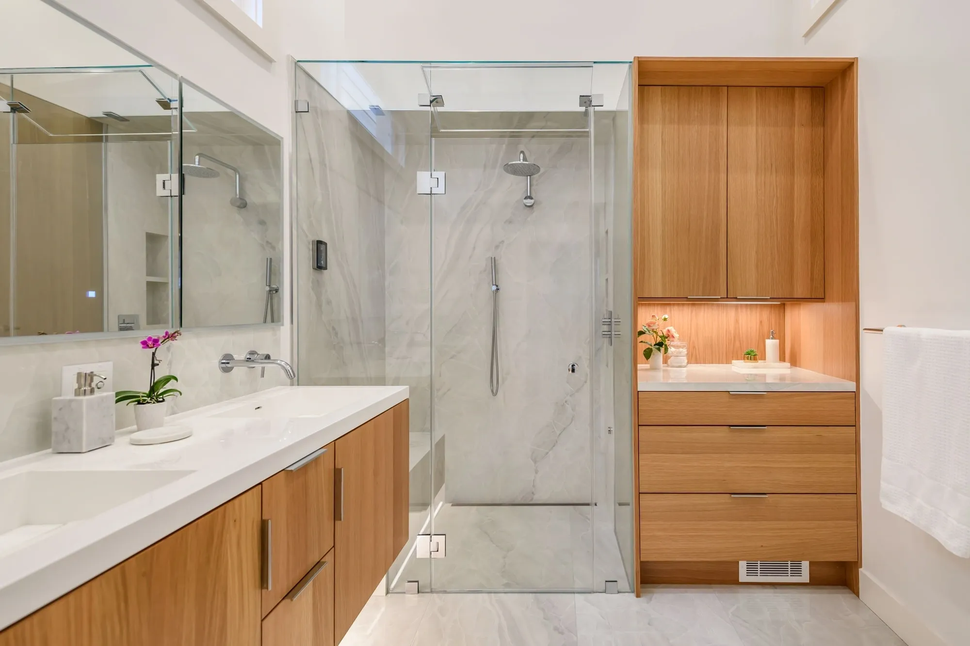 Modern bathroom with glass shower and wood cabinetry
