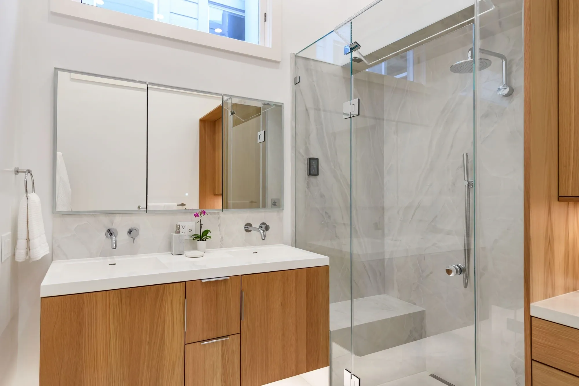 Modern bathroom with wood vanity and glass shower