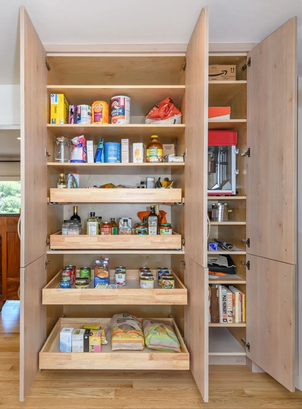Open wooden pantry with organized food items