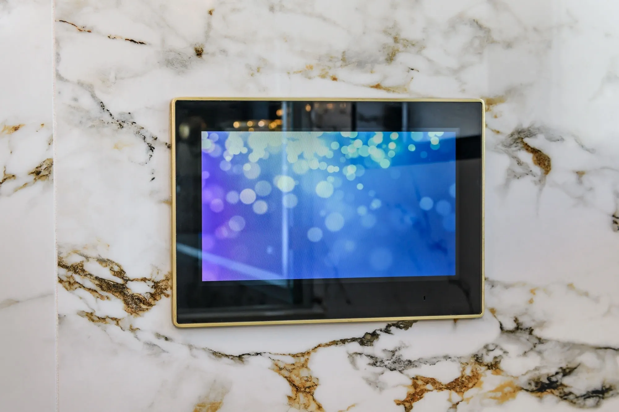 Wall-mounted touchscreen with blue bokeh screen
