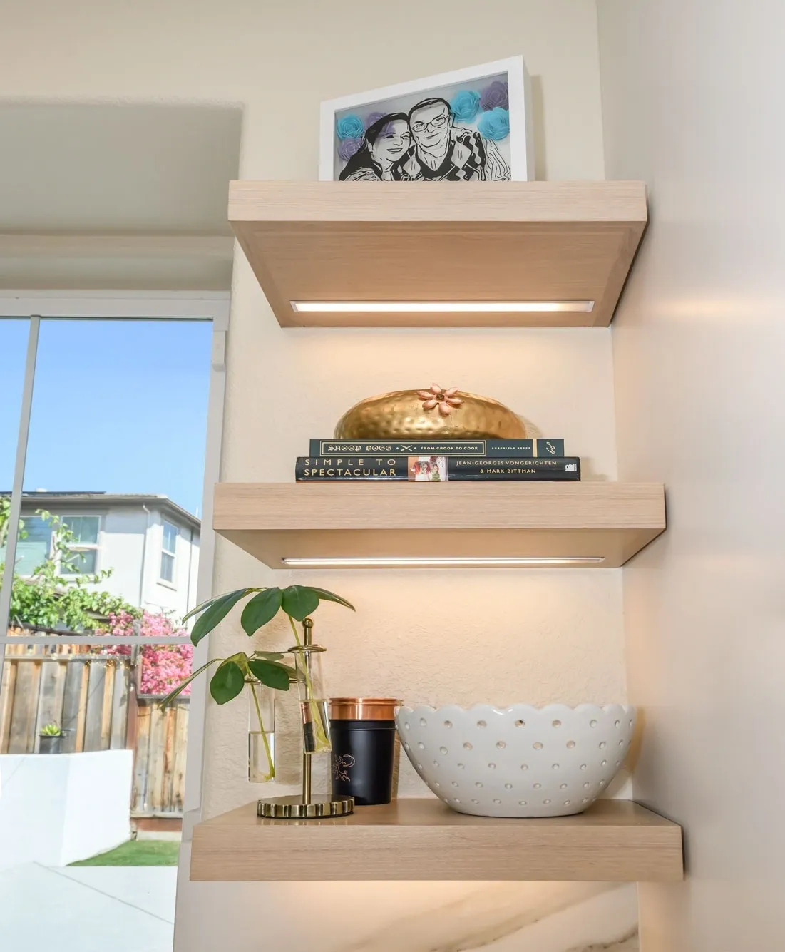 Three lighted floating shelves with decorative items