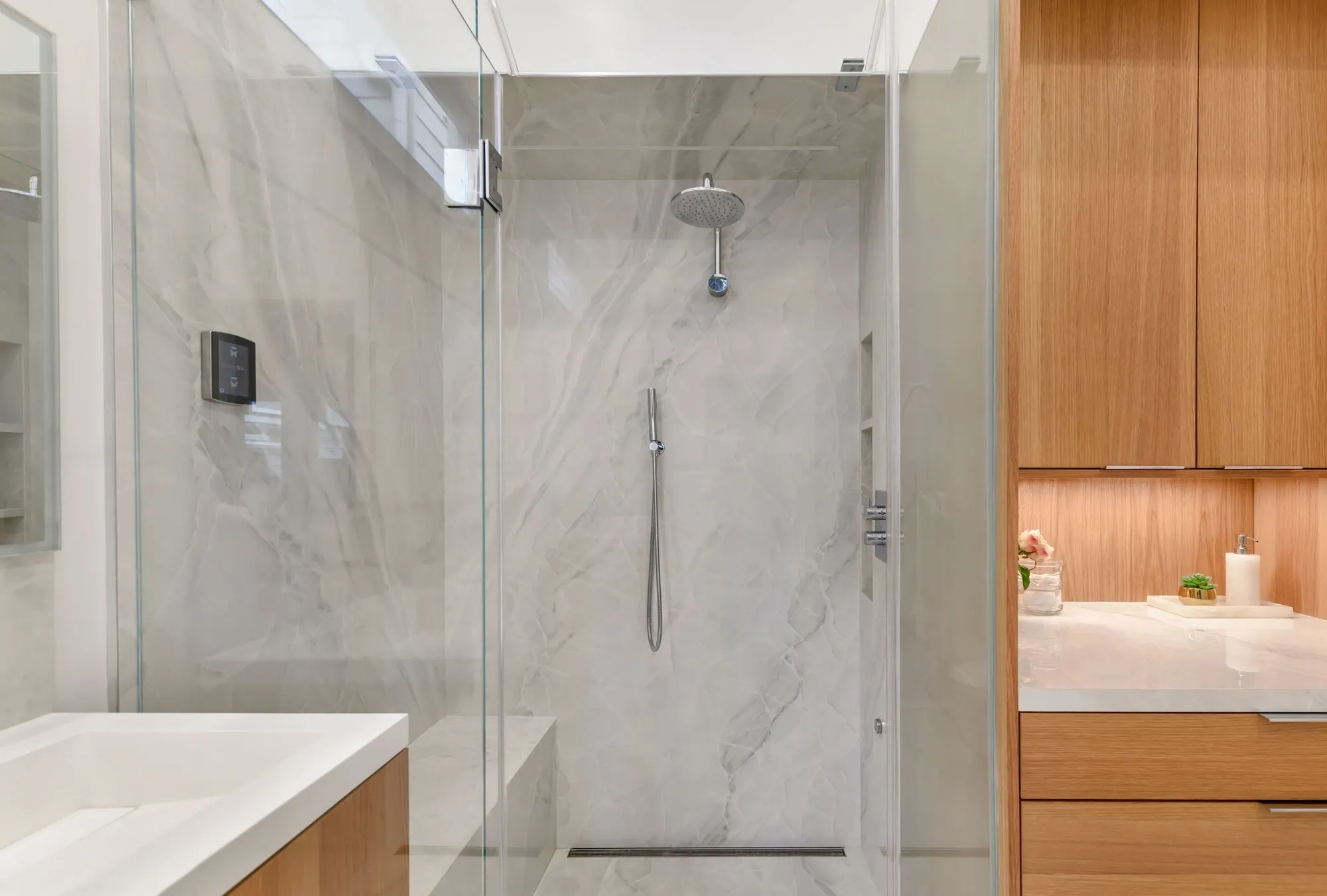 Glass walk-in shower with marble walls