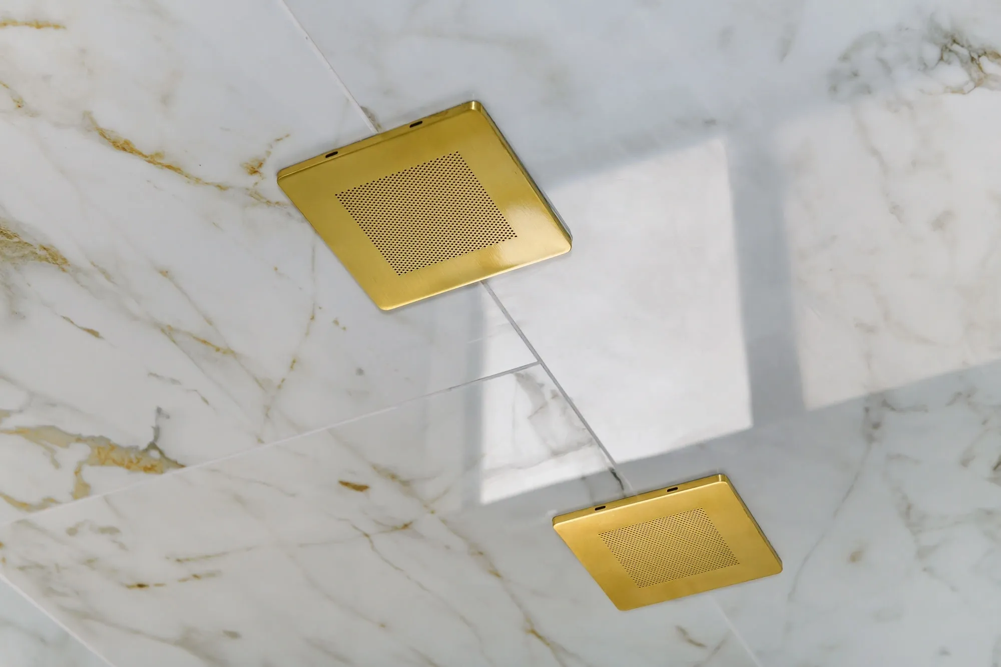 Gold square ceiling fixtures on marble