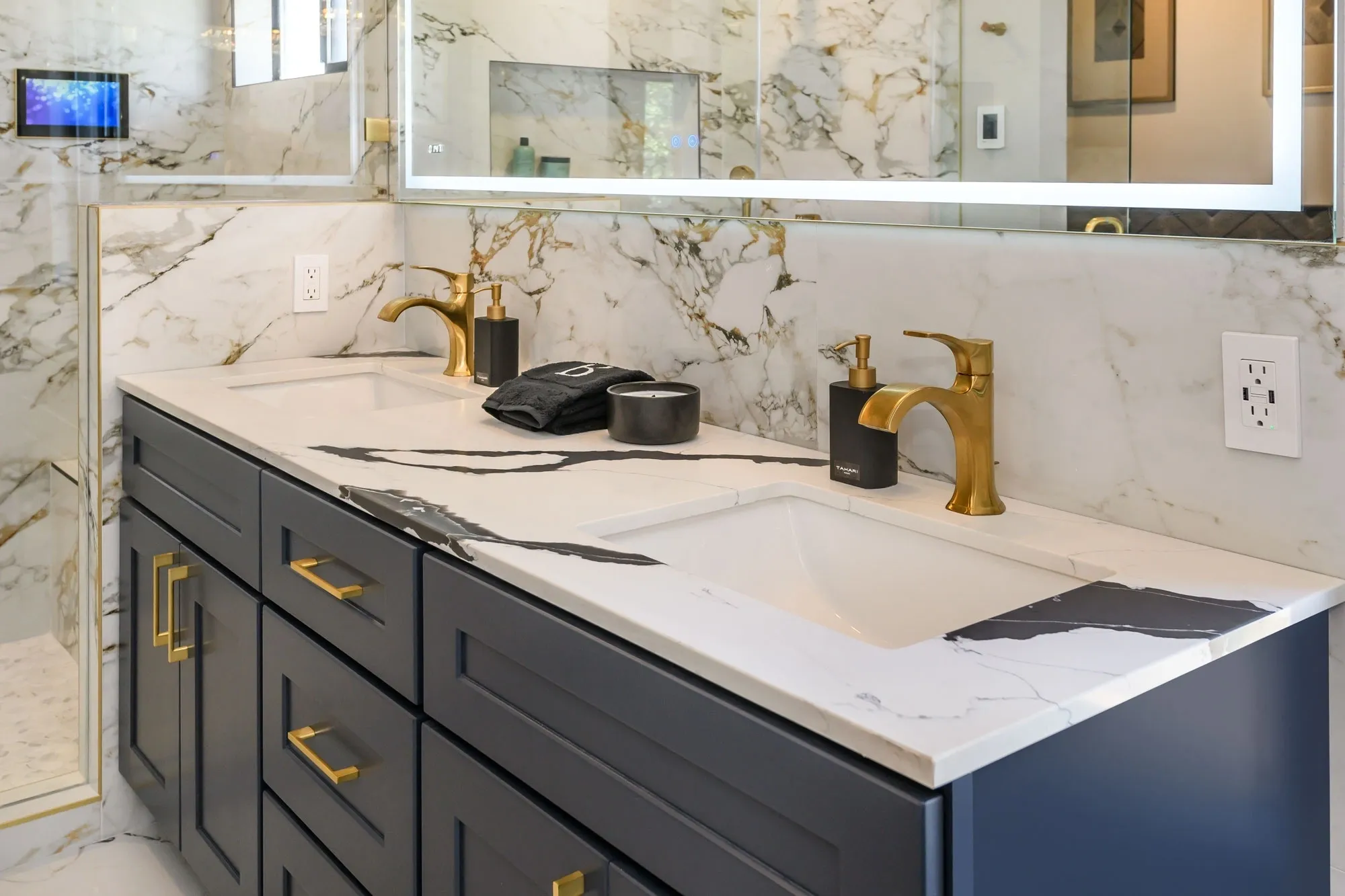 Double sink bathroom vanity with gold faucets