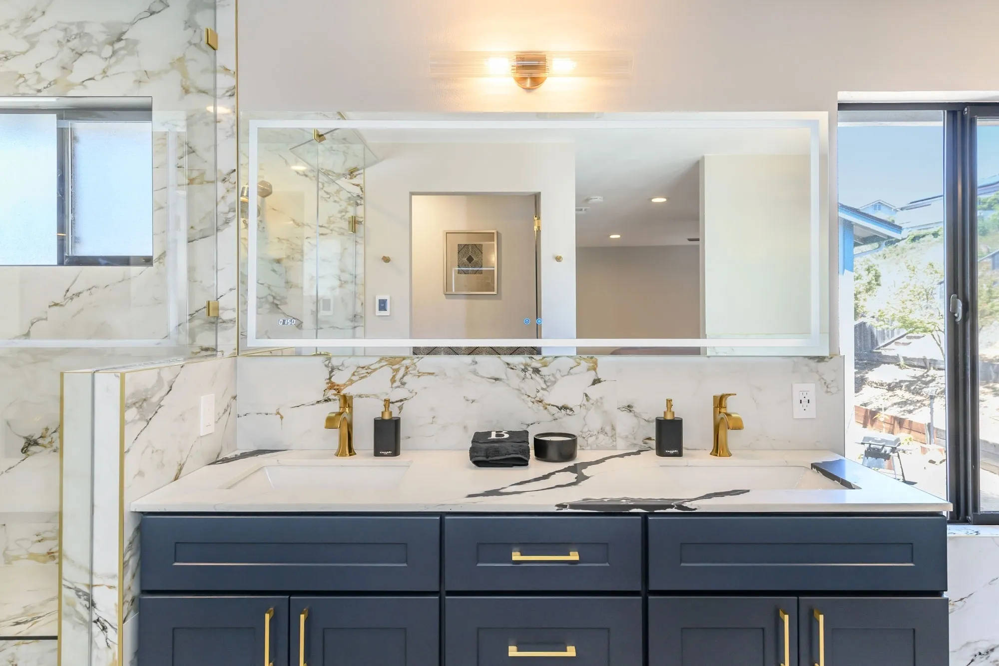 Marble double-sink vanity with navy cabinets
